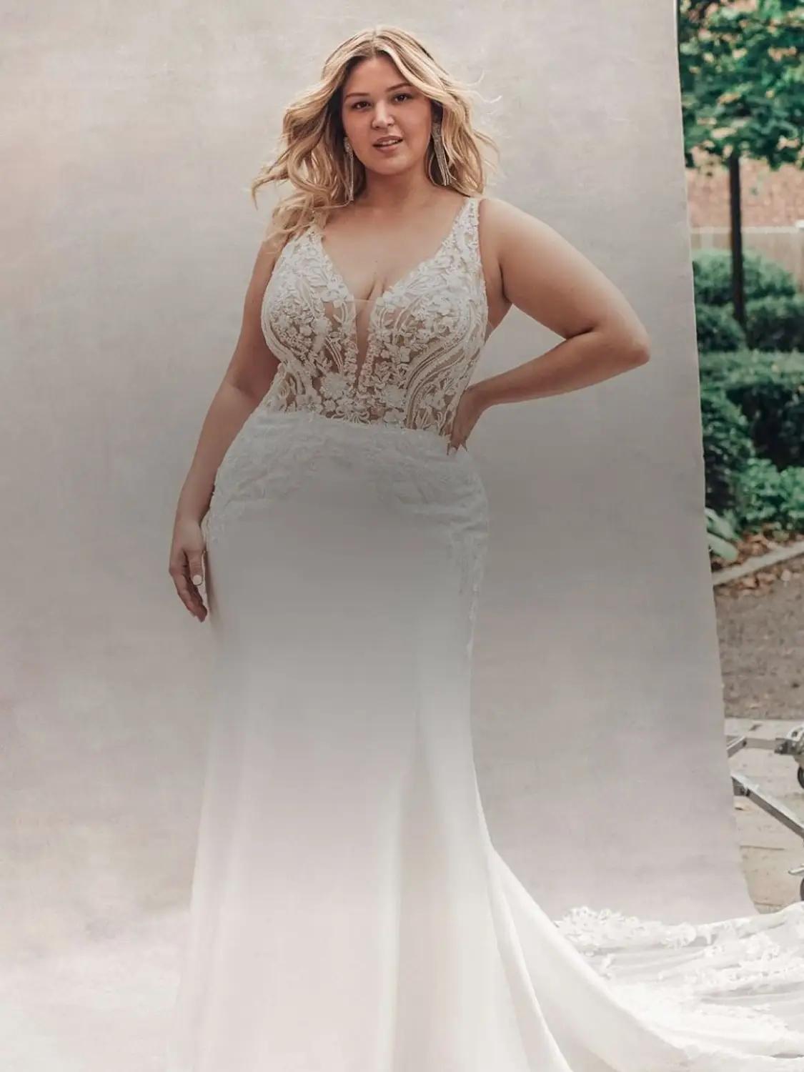 Plus size models wearing a white gown. Mobile image