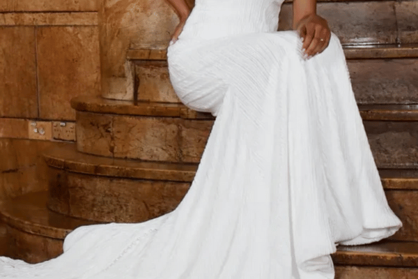 A woman in a georgette wedding dress sitting on the stairs
