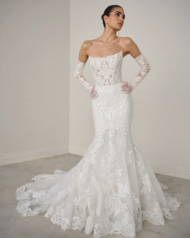 Bride in her beautiful wedding gown with lace fabric