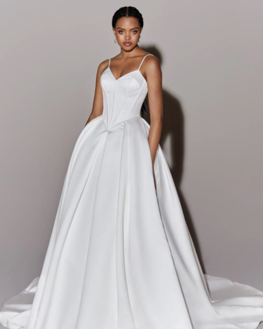 A woman of color in her white satin wedding gown