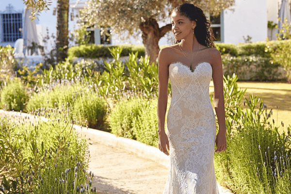A bride in a Lillian West wedding gown with sweetheart neckline