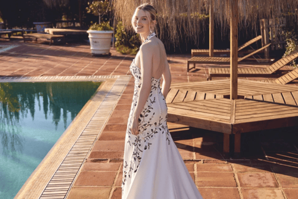 A beautiful bride in her white wedding gown with 3D Lace Appliques and halter neckline