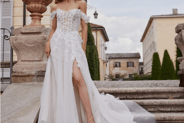 A woman walking down the stairs in her a-line wedding gown on her way to her outdoor wedding