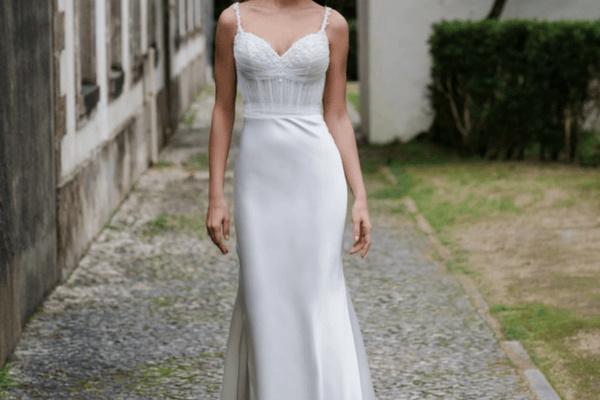 A woman in her sheath dress getting ready for her outdoor wedding ceremony