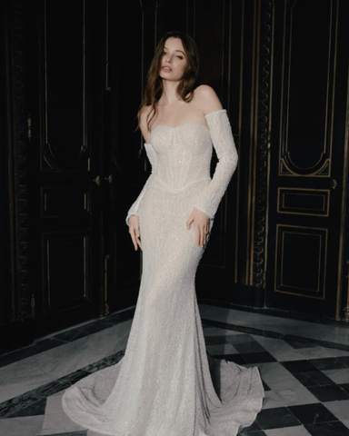 A woman in her sheath wedding dress in a vintage inspired room