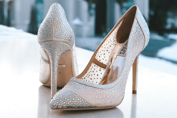 White crystal bridal pumps with pointed toes and high heels for an elegant bridal look.
