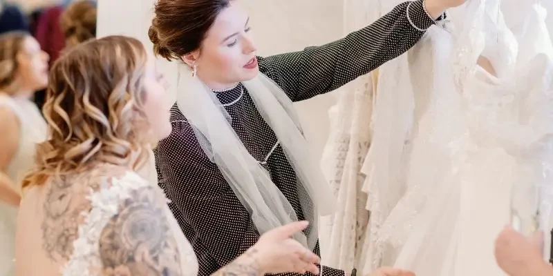 bridal consultant helping a bride try on bridal gowns in Toledo Ohio